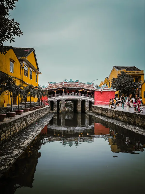 The Japanese Covered Bridge reflected in a still canal between yellow houses